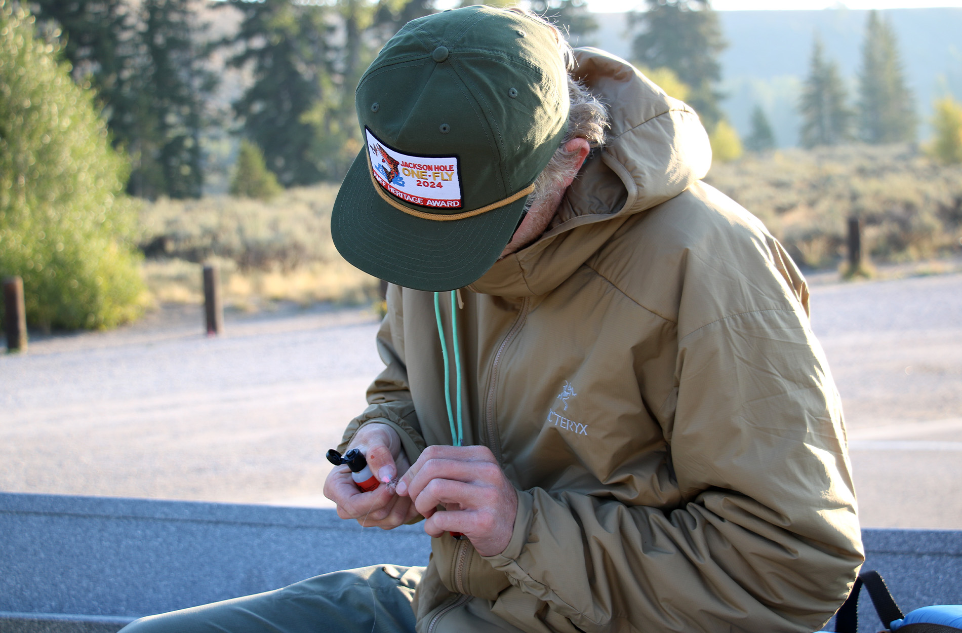 A fly fishing guide ties on a dry fly.