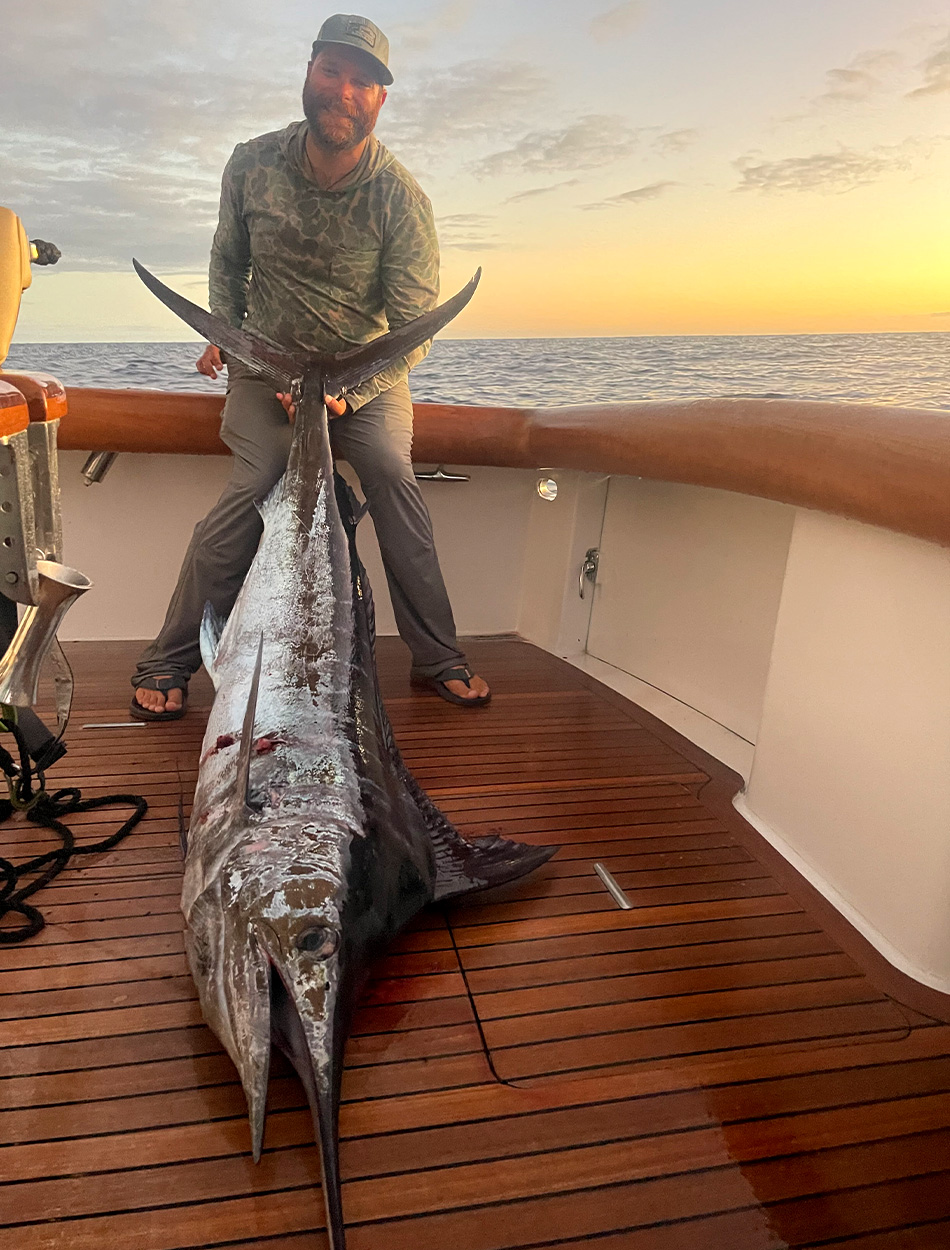 An angler with a harvested blue marlin.