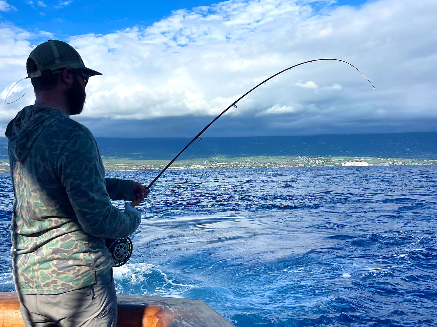 A fly fisherman battles a blue marlin.