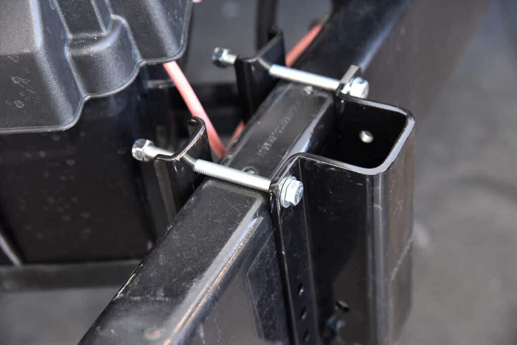 The lower pockets for the rear support pipes are then loosely bolted to the frame using the supplied 5/16x4-inch hardware. These may need to be slid forward/backward depending on your trailer setup. Our Reflection 313 RLTS needed the brackets mounted even with the battery tray.