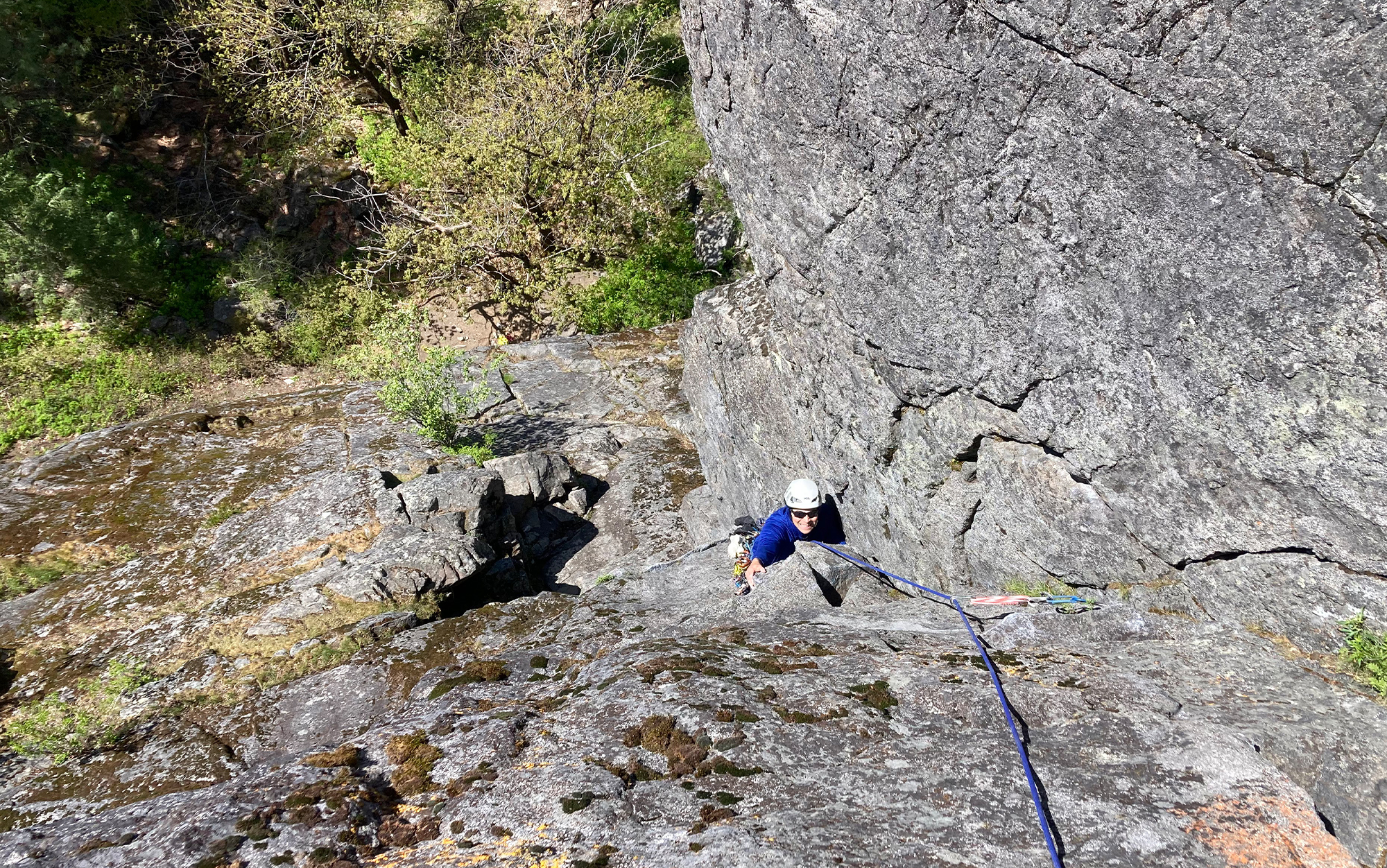 Climber ascends in approach shoes.