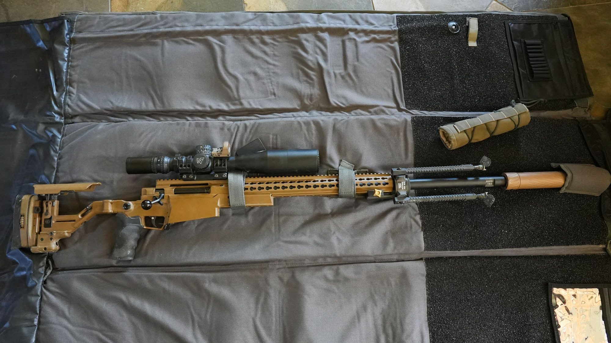 Rifle sits on the Ulfhednar Guncover-Shooting Mat.