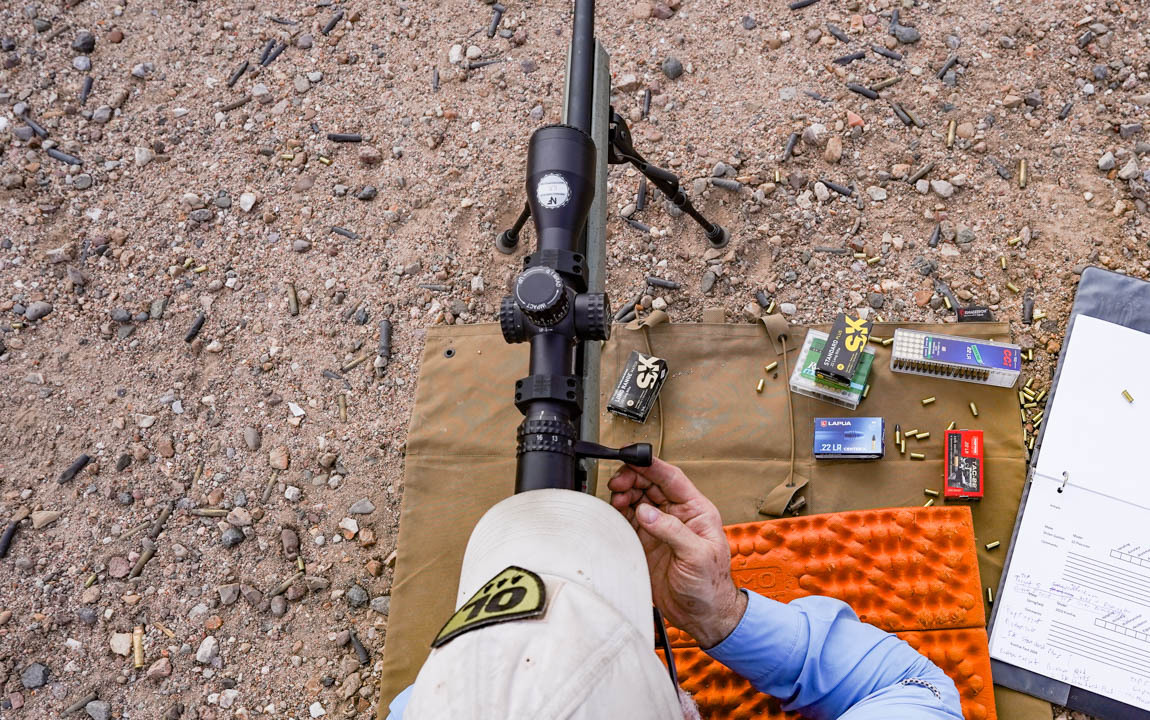 Tester shoots rifle prone.