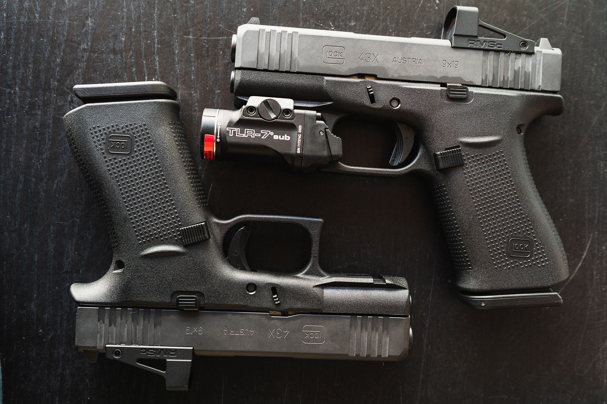 Two Glock 43X pistols with lights and red-dots.