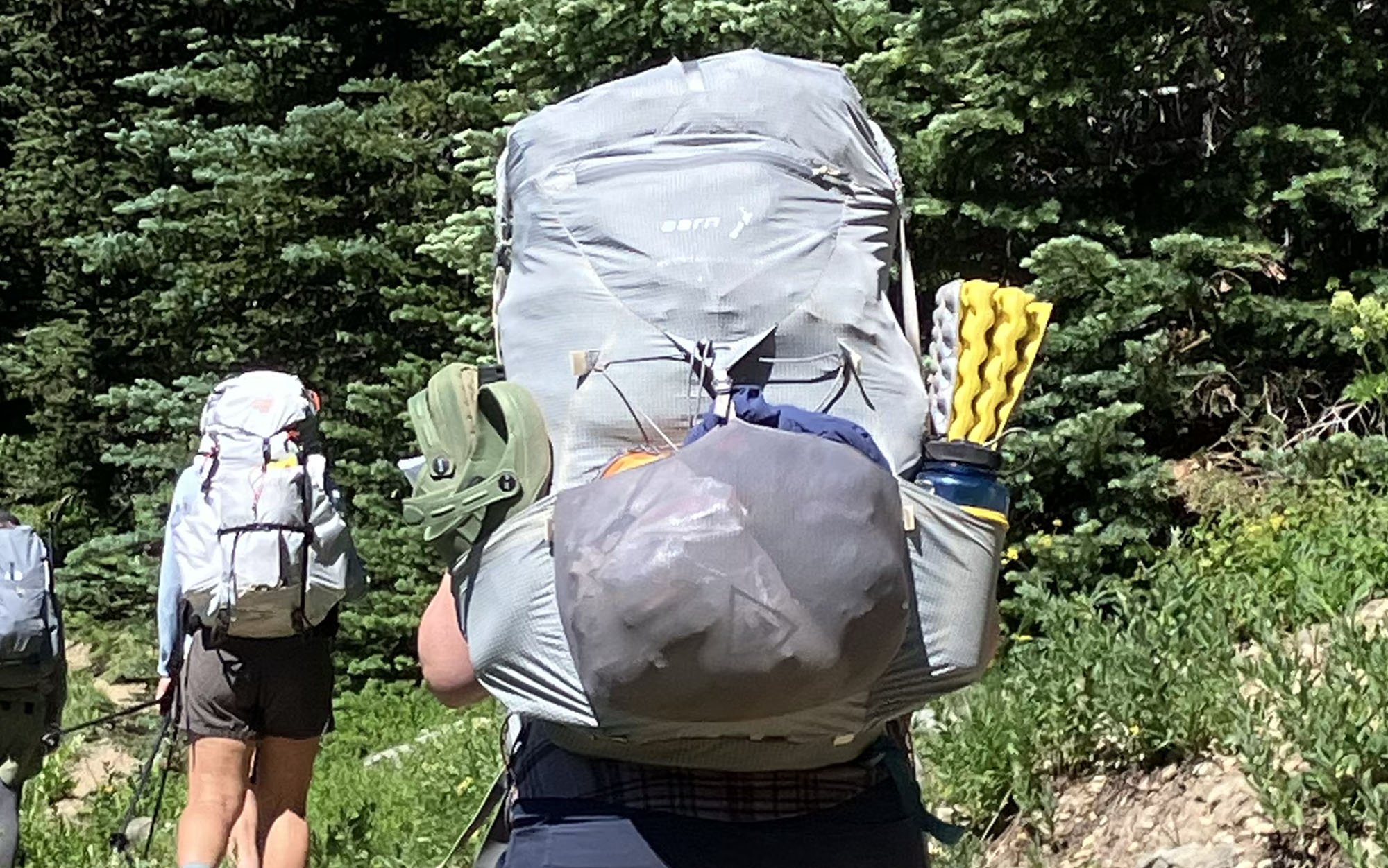  closeup shot of the Aarn Mountain Magic 50 Pro on the trail with another hiker in the background