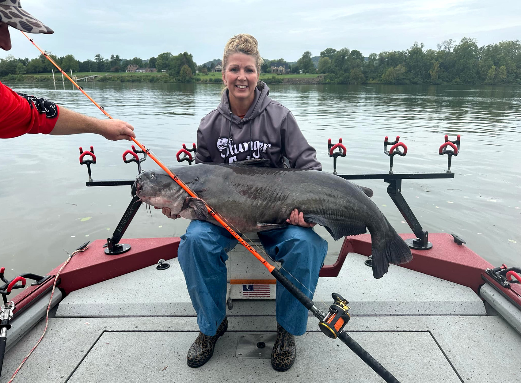 An angler with a big blue catfish caught from the Ohio River.