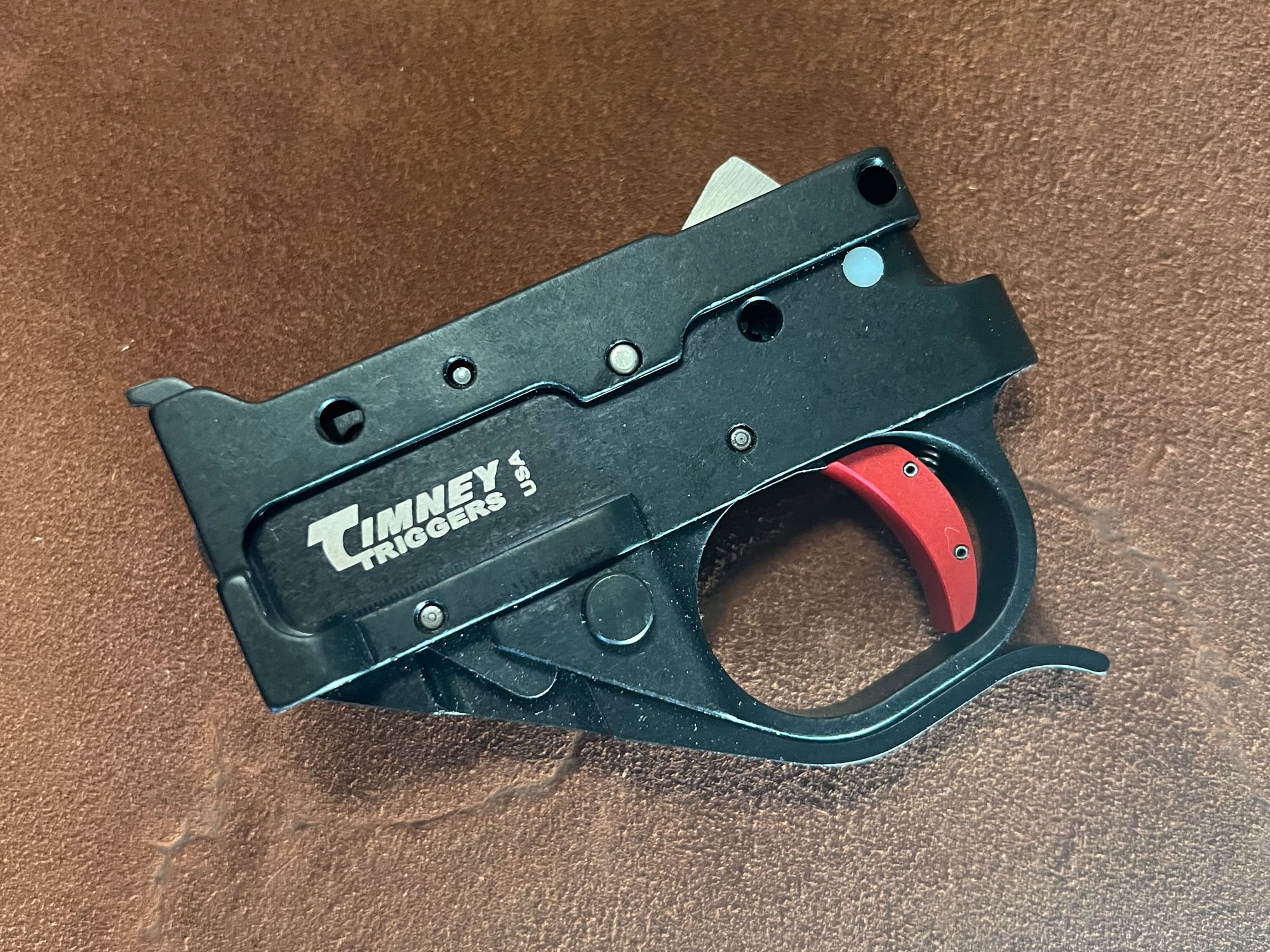  The Timney replacement Ruger 10/22 trigger on a leather background