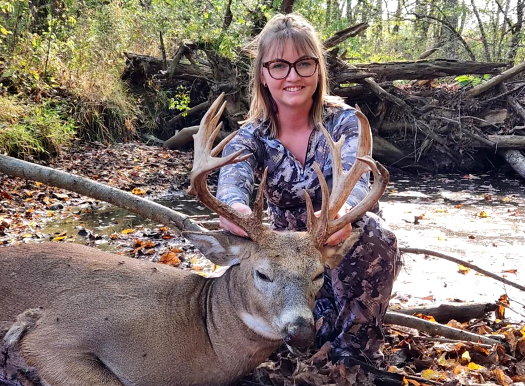 An Ohio bowhunter with a buck she tagged in October.