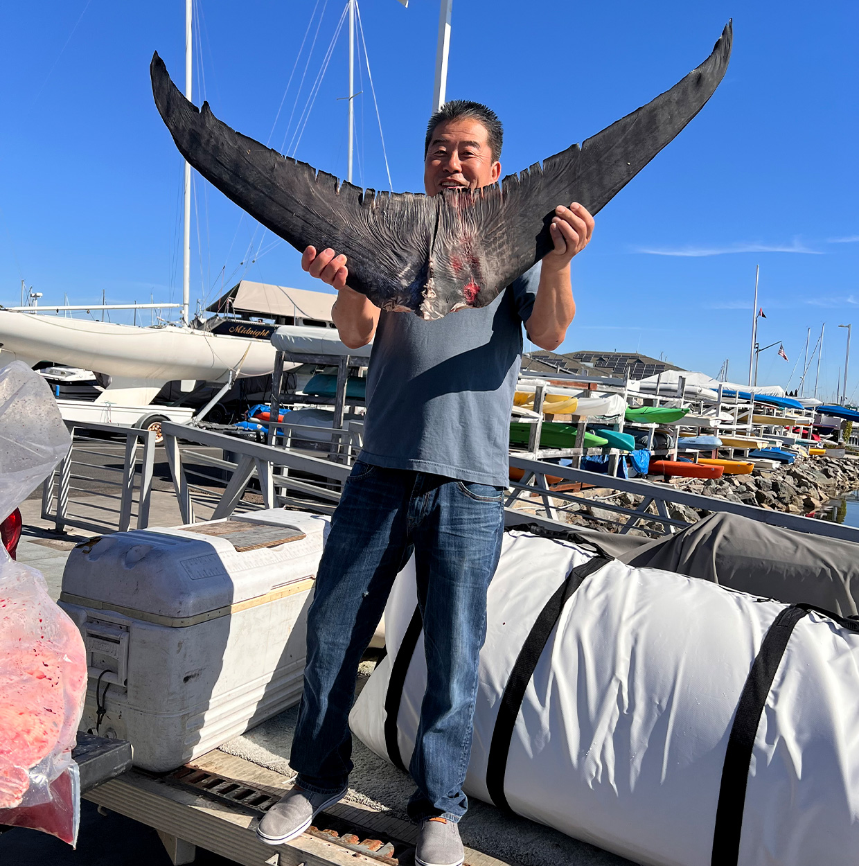 A Calfornia angler with the tail of a swordfish.