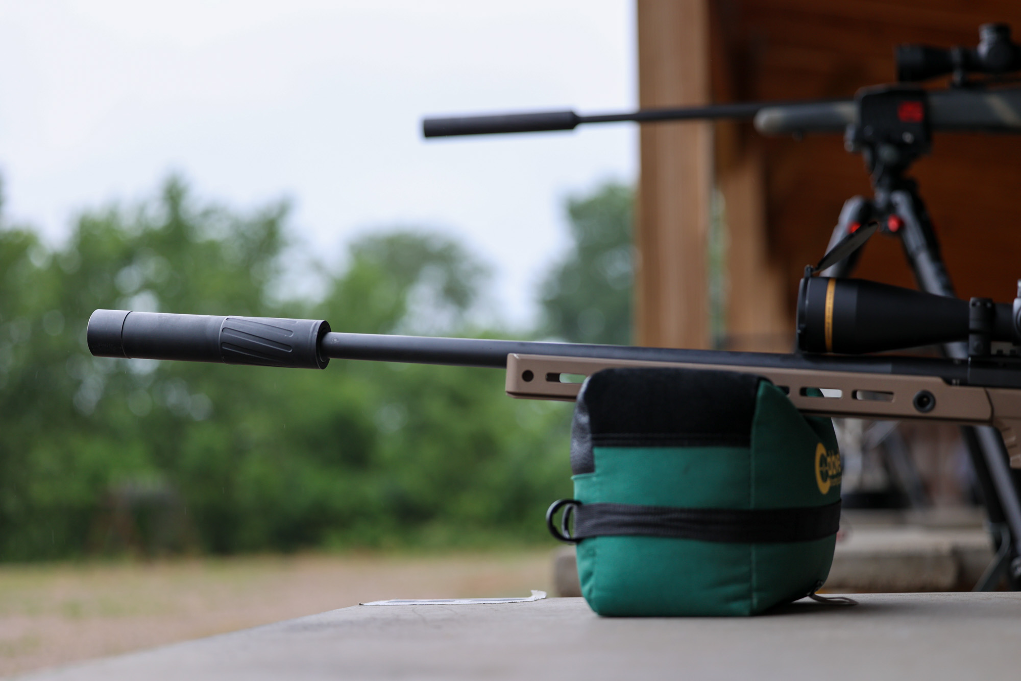 Two suppressed rifles at the range.