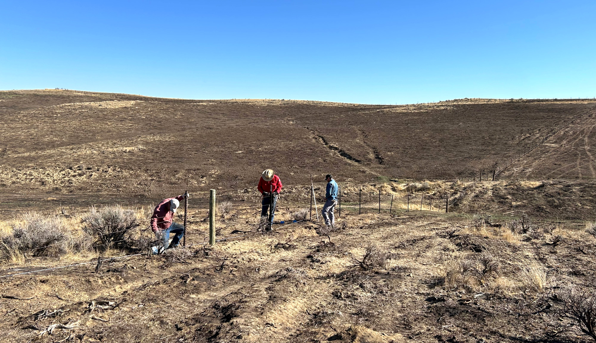 A group of landowners rebuild fence in Wyoming.