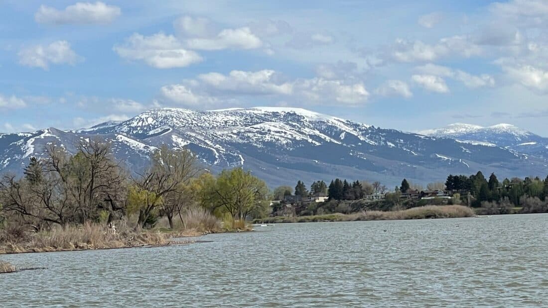 Snow-capped mountain over a lake in Idaho.