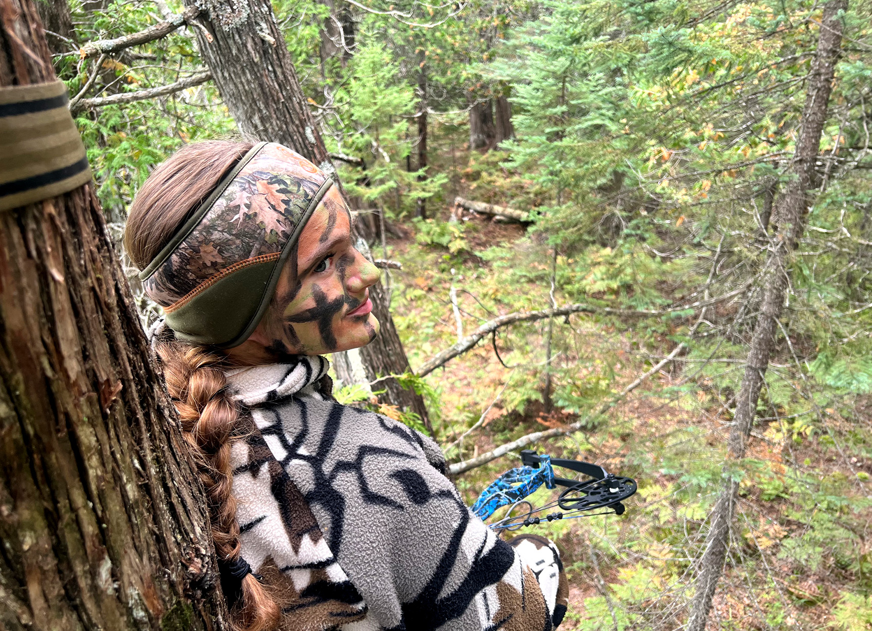 A young Michigan hunter sits in a tree stand.