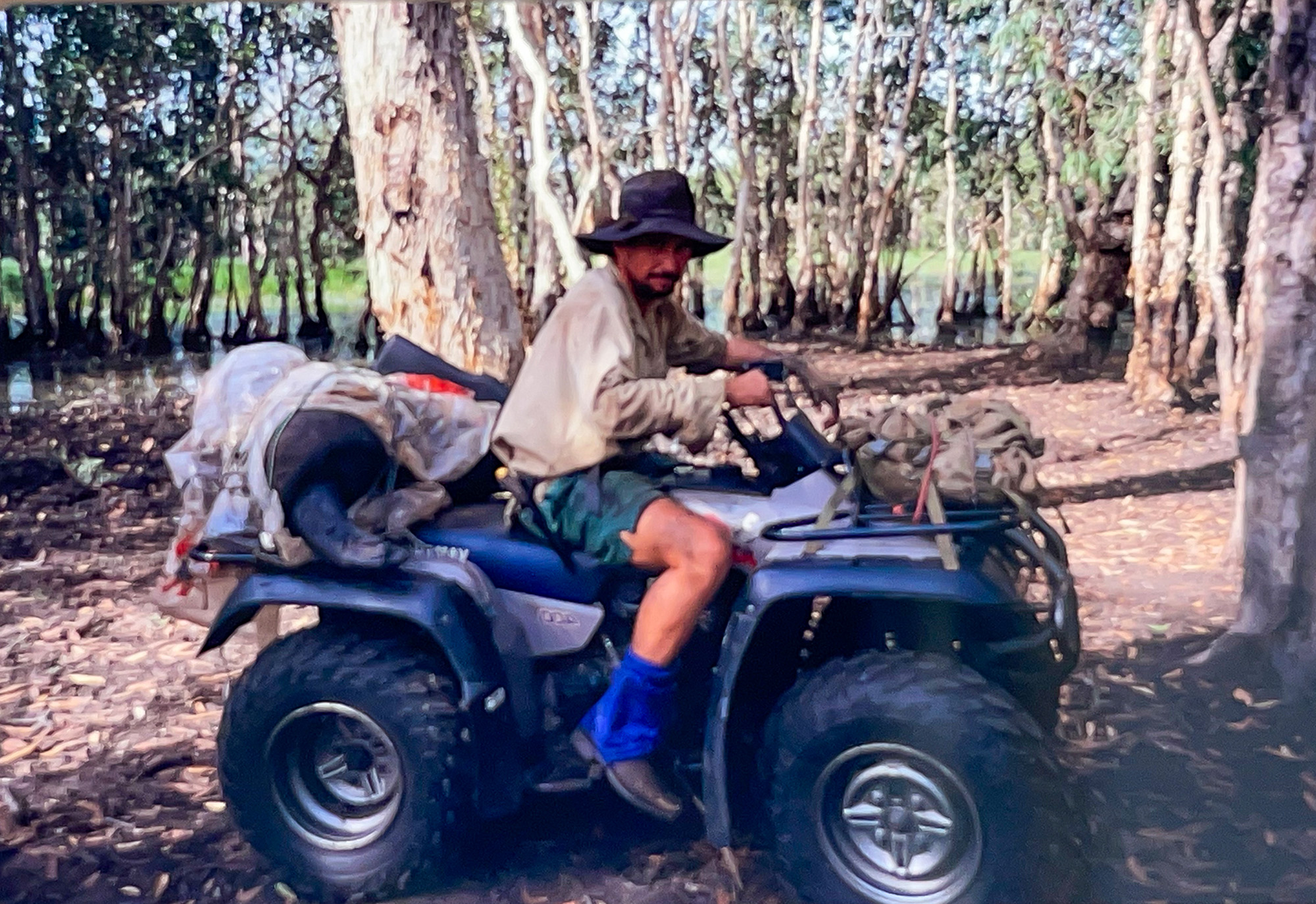 An Australian guide sits on a quad during a buffalo hunt.