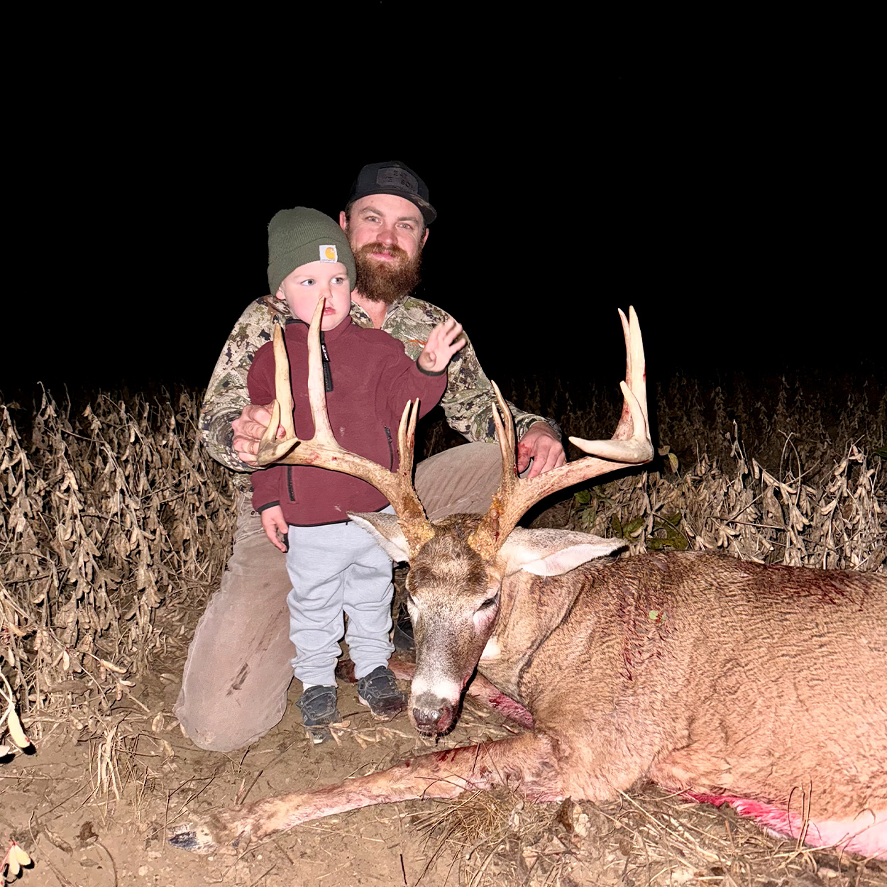 An Ohio hunter and his young son with a buck.