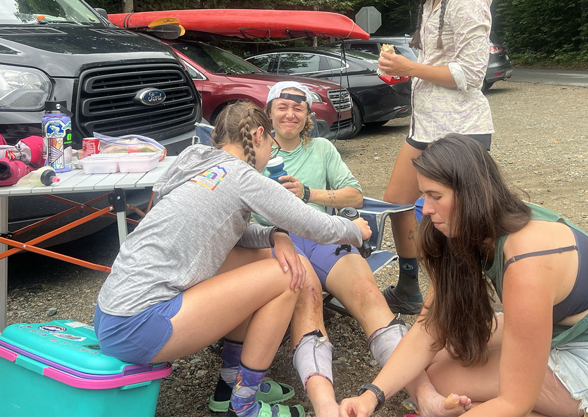 Tara Dower rests in a chair while her support crew preps her for more running.