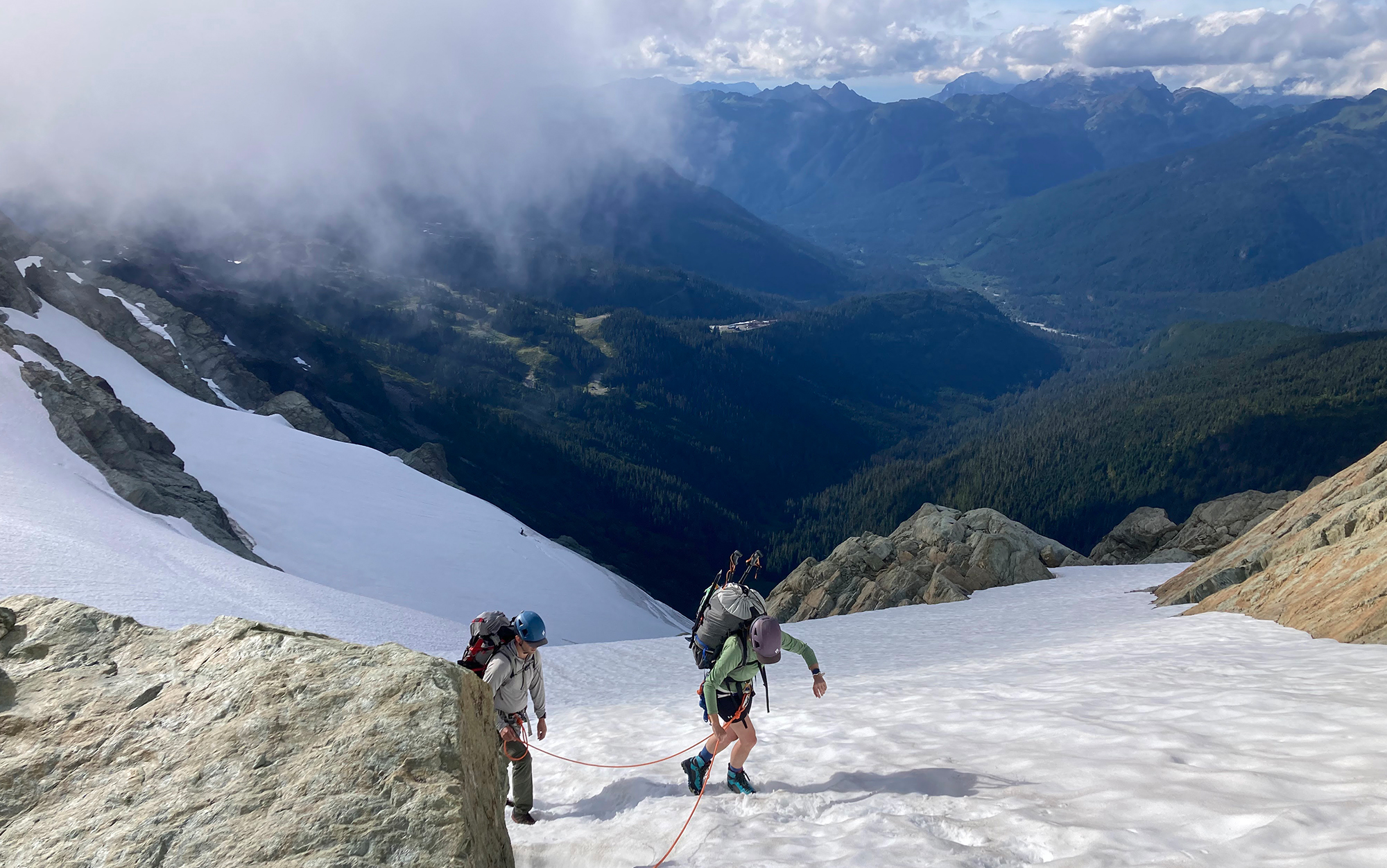 Mountaineers traverse snowfield.