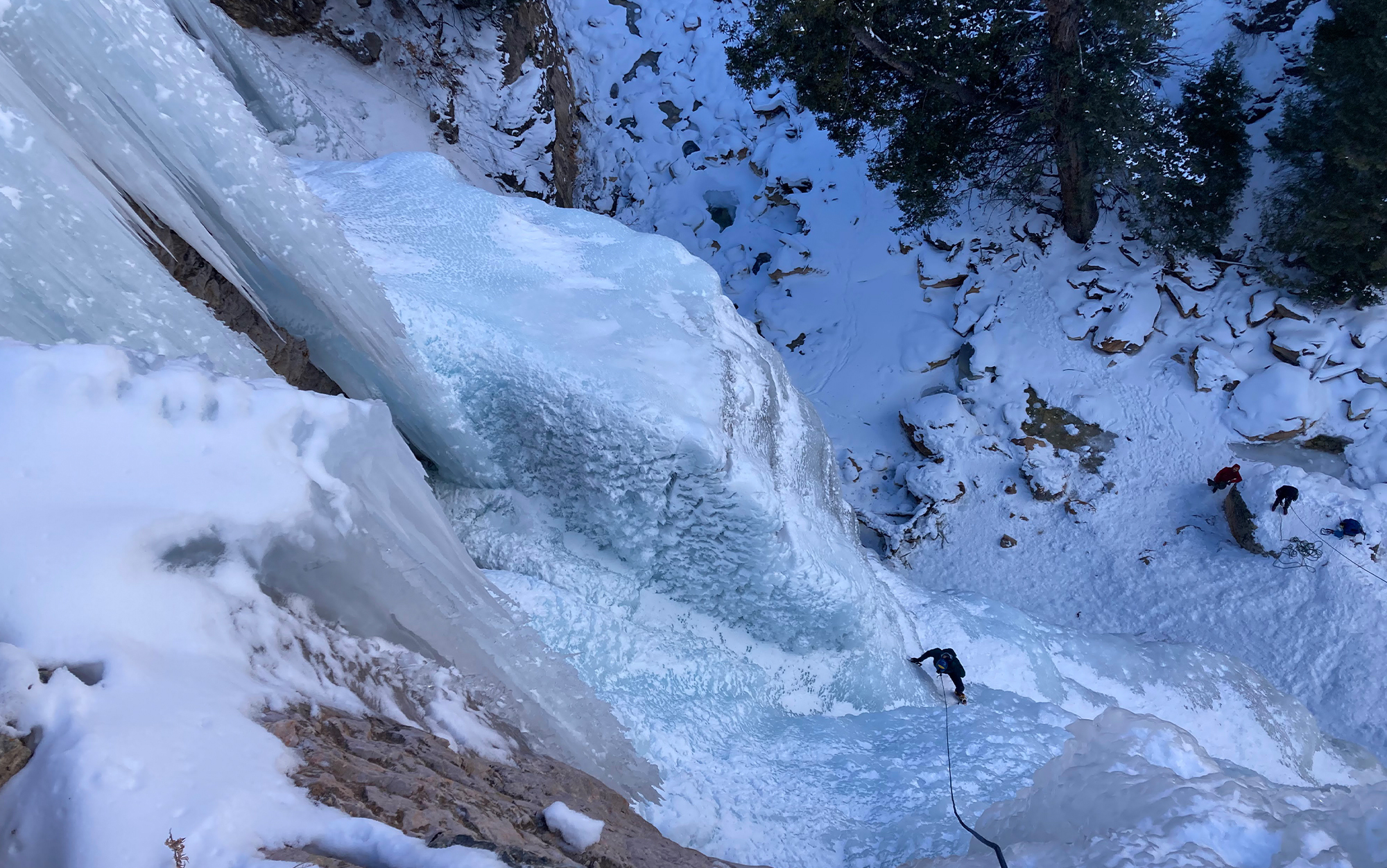 Mountaineer climbs ice wall.