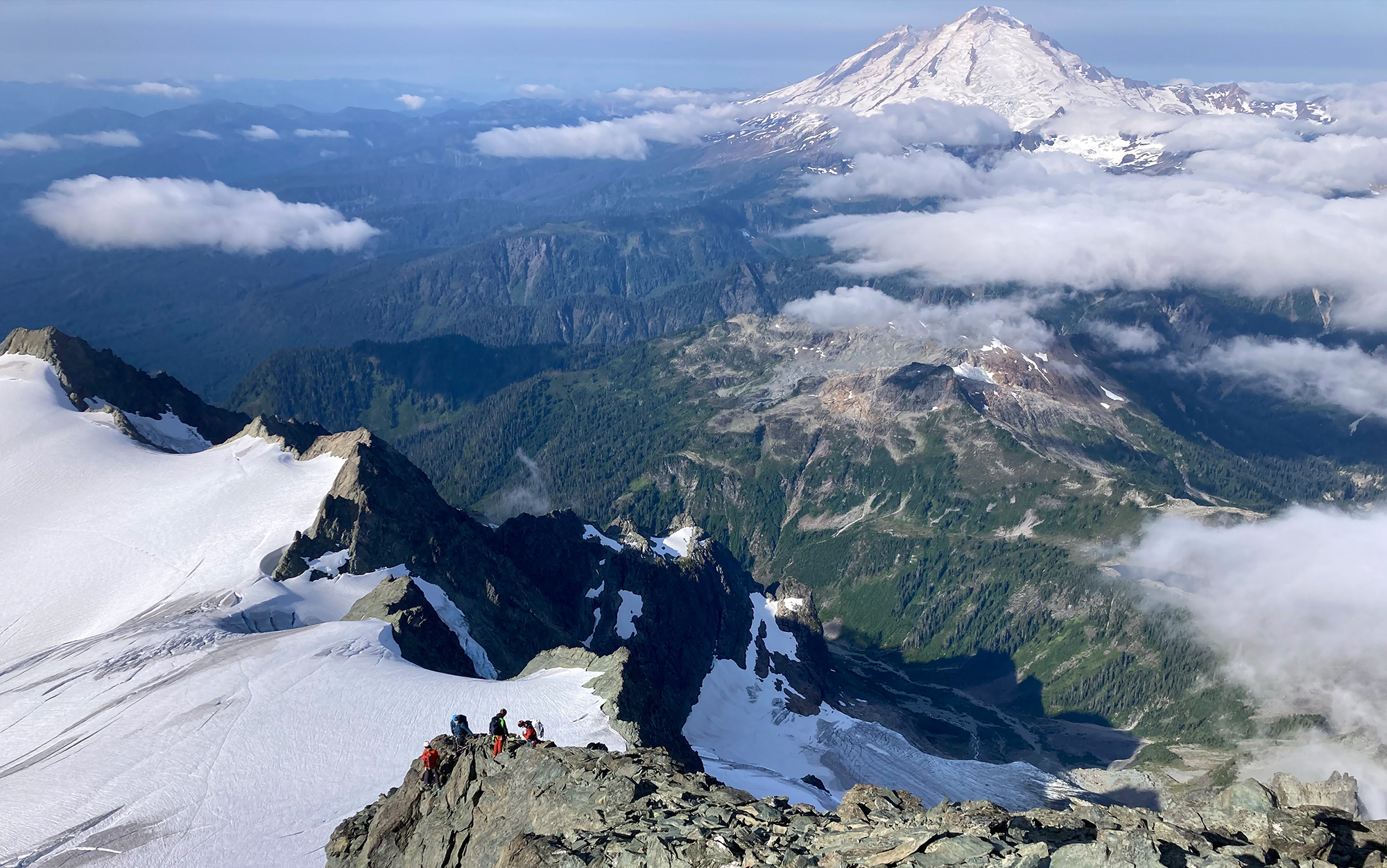 Climbers pause on a ridgeline to take in the view.