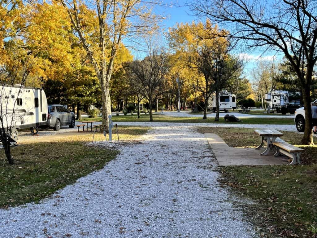 An empty pull-thru site in a fall setting at Big Red Barn RV Park in Missouri.