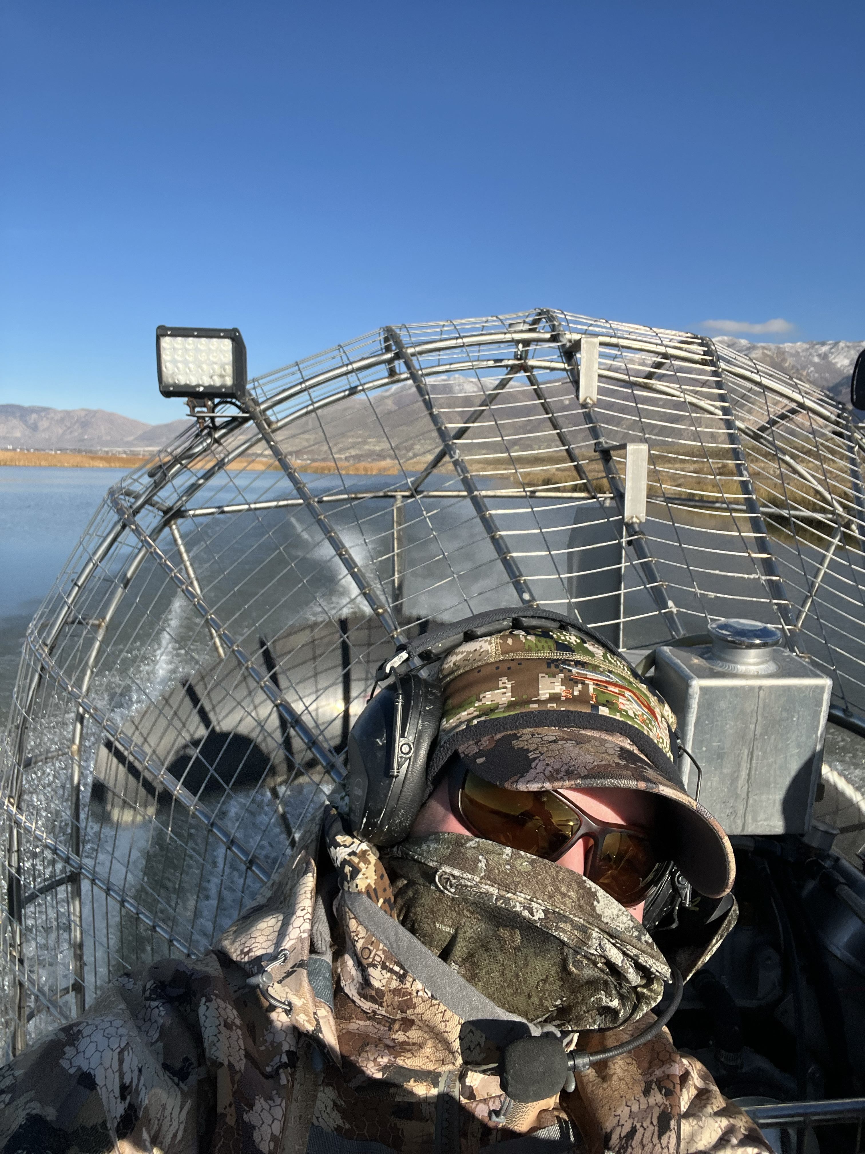 Author sits in front of air boat propeller.