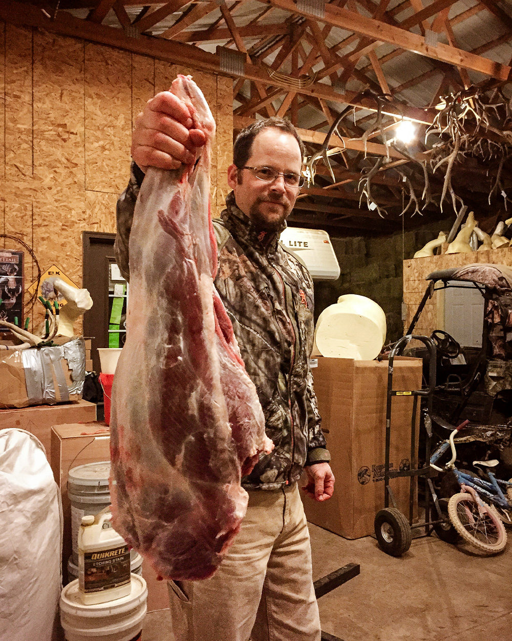 Hunter holds up mountain lion quarter.