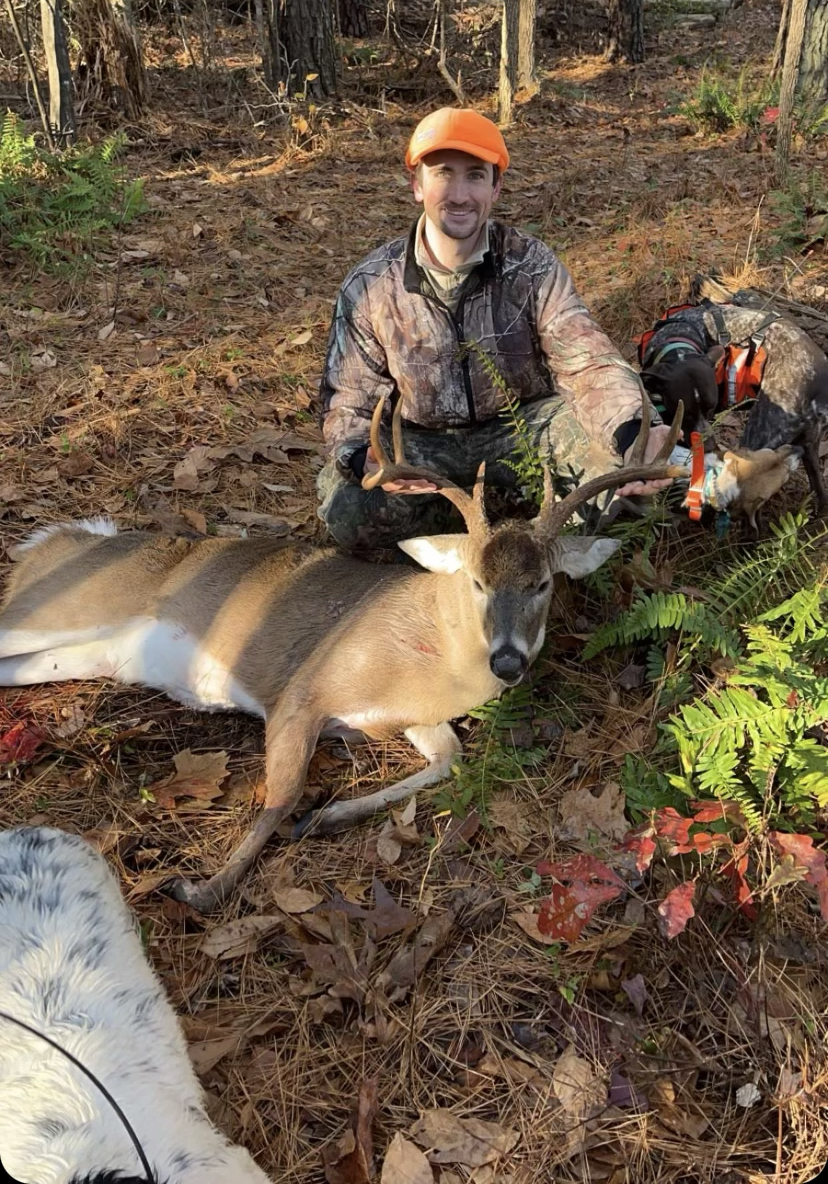 A hunter with a buck.