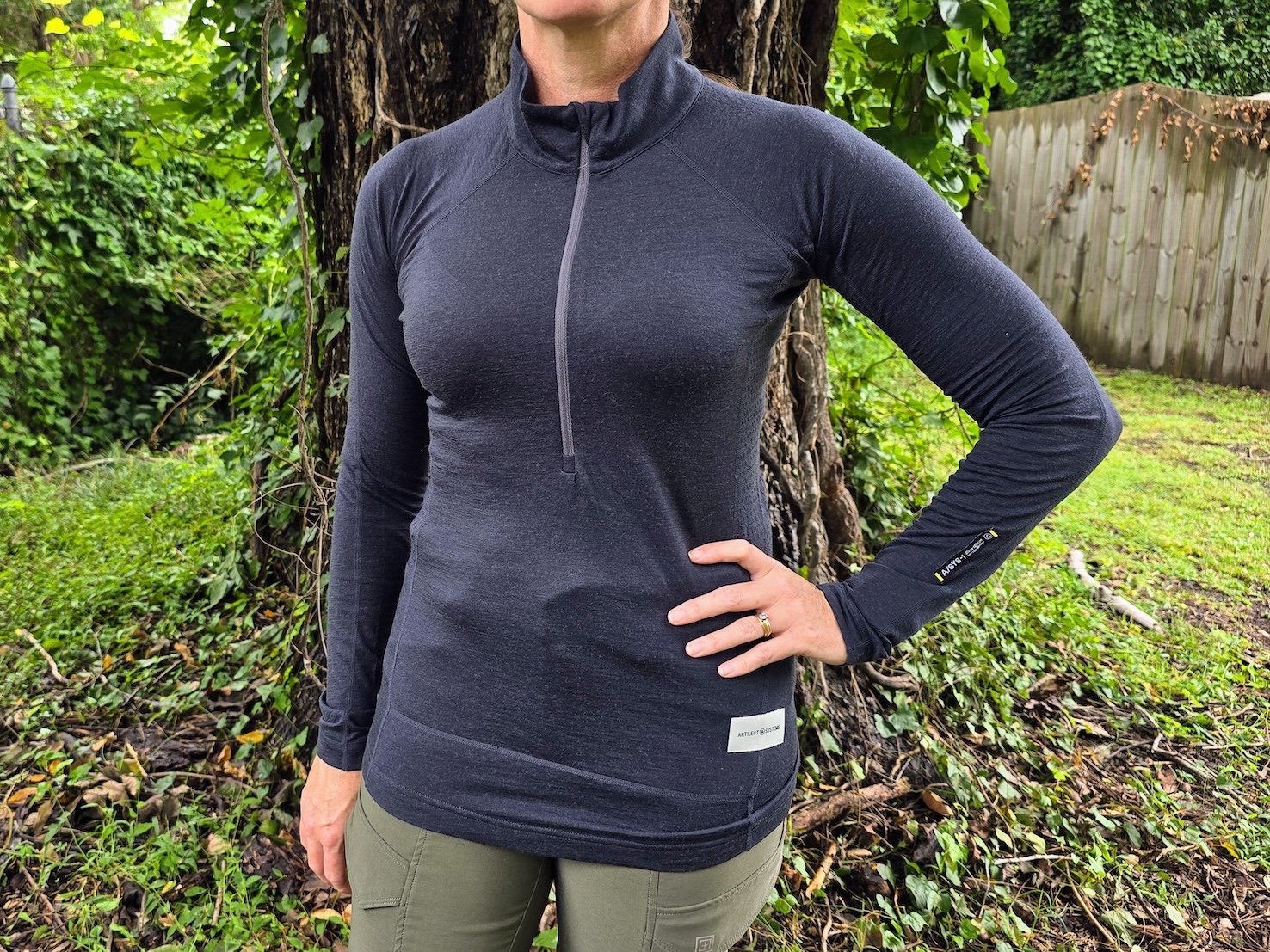 A close-up of a woman wearing a gray wool base layer top.