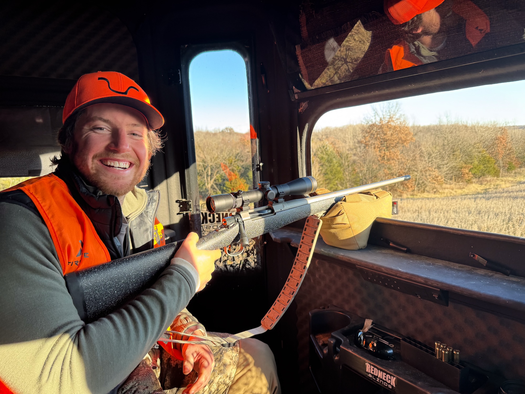 A new hunter grins in the blind.