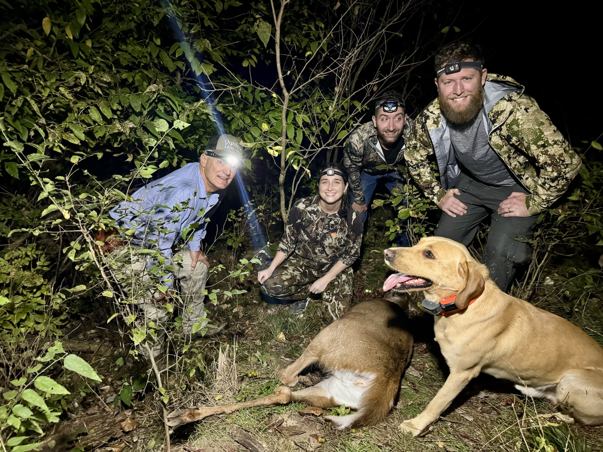 A group of hunters recover a doe after blood trailing.