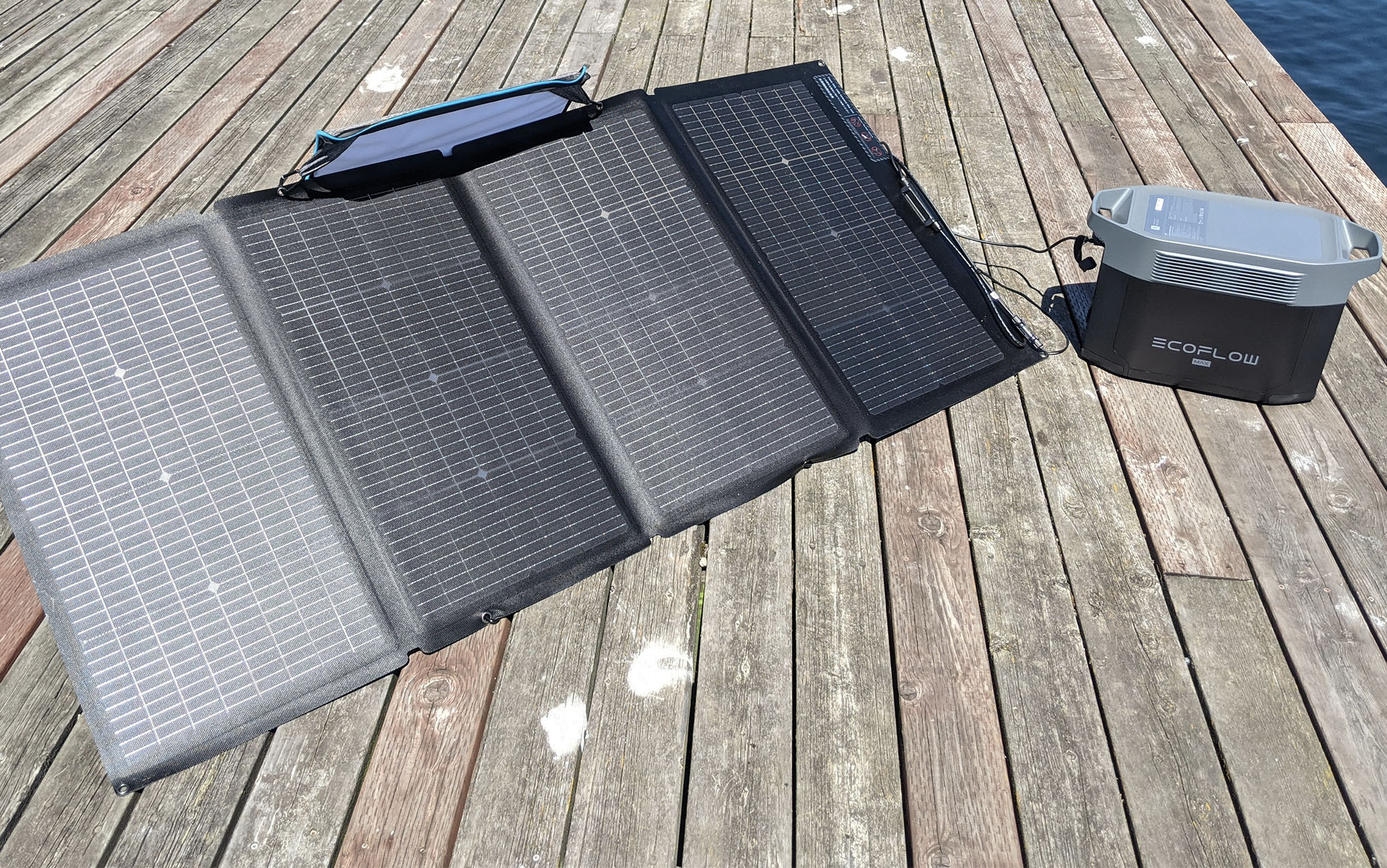 ecoflow 220 watt panel and power station on a dock in full sun