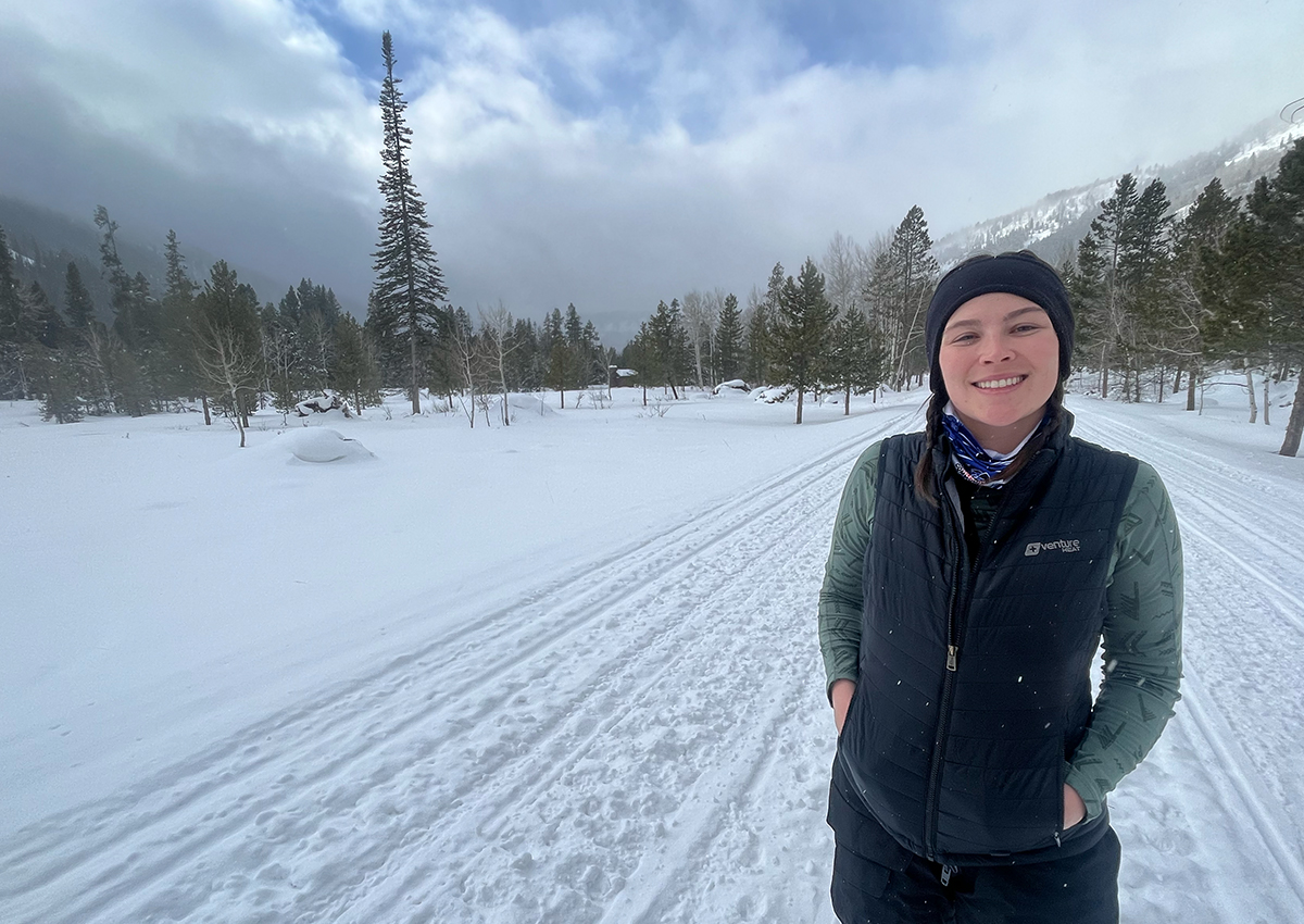 Woman wears one of the best heated vests snowmobiling.