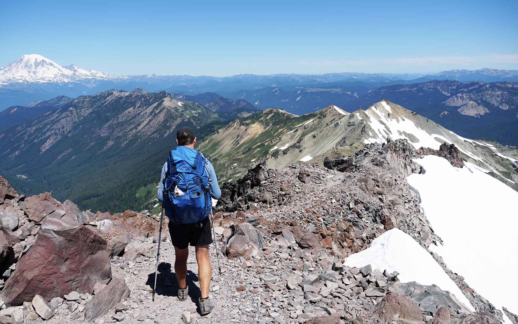 Osprey Exos walking down a mountain