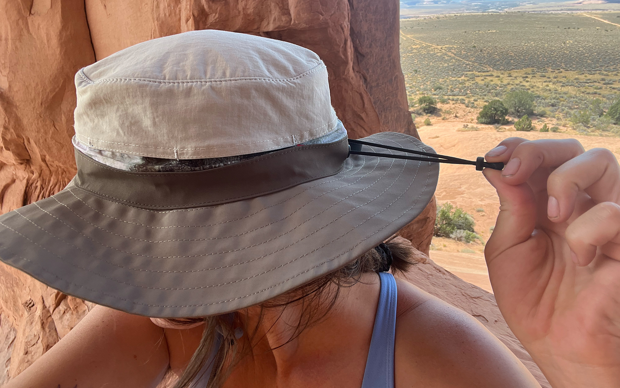 Author tightens sun hat.