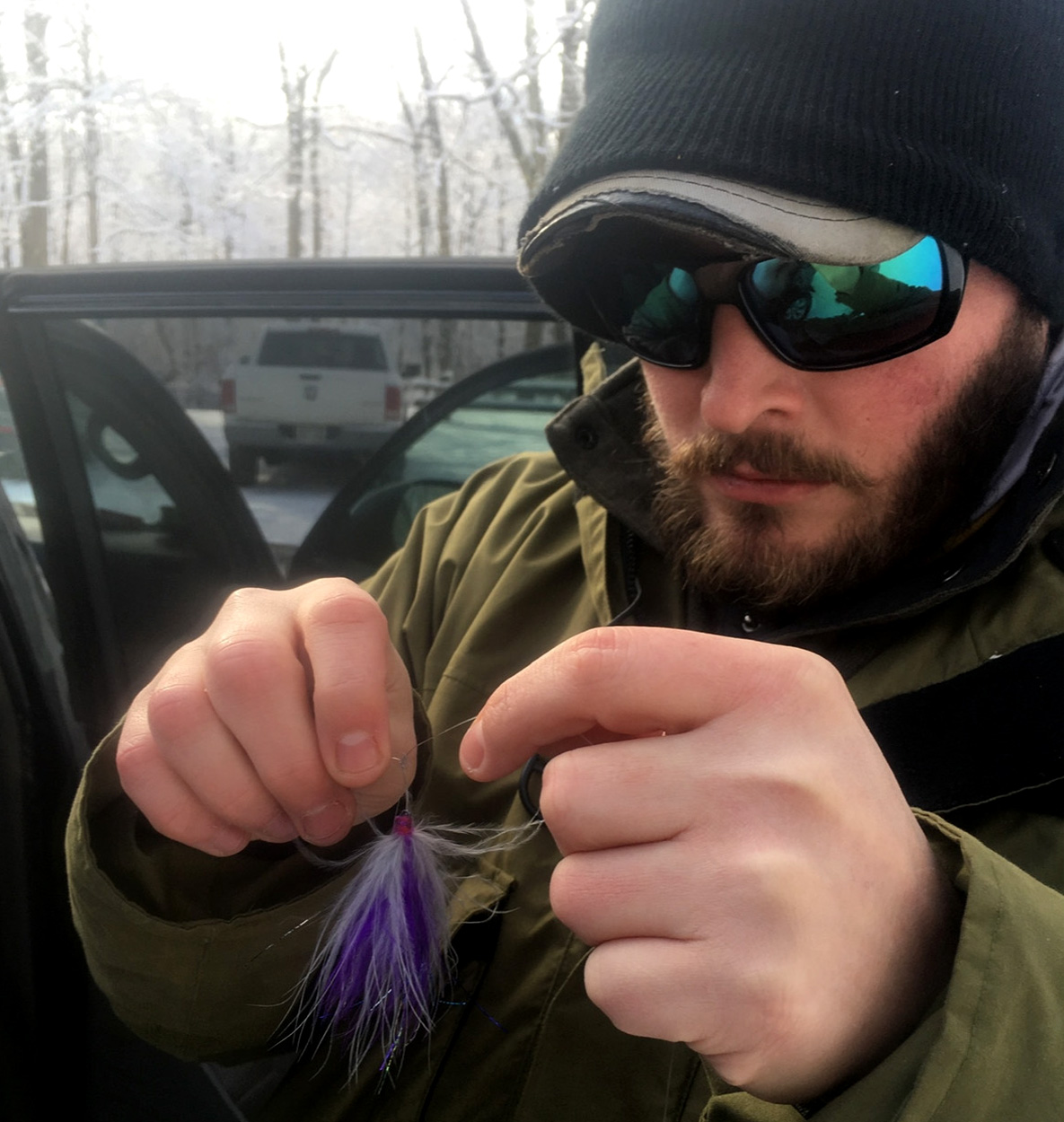 A fly angler ties on a new fly.