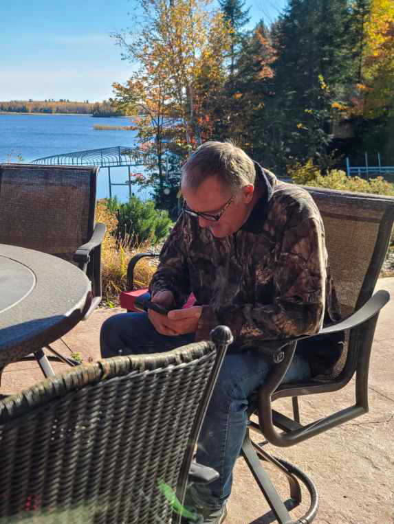 A man looking at photos on his phone.