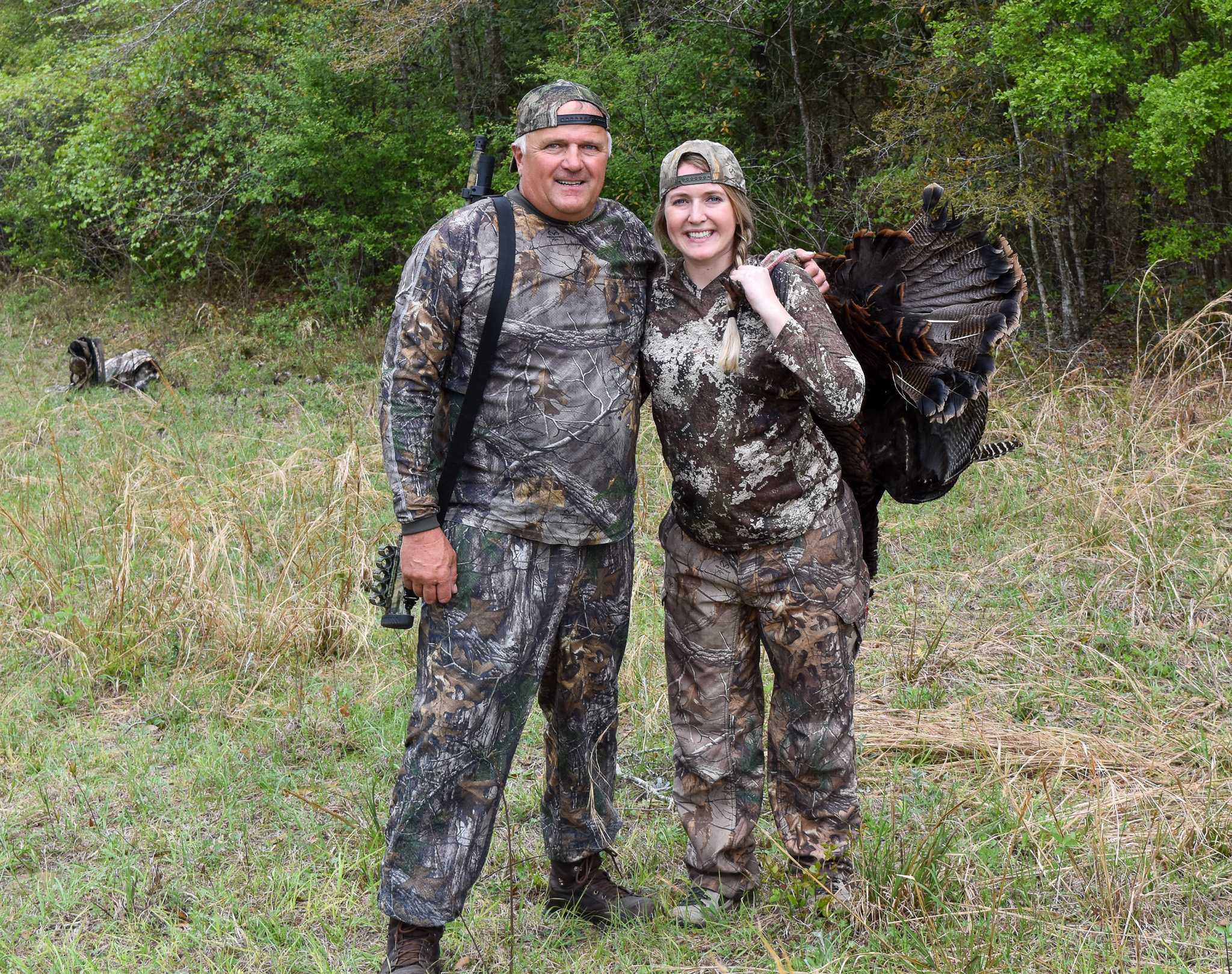 A father and his daughter turkey hunting.