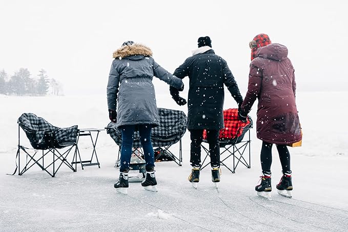 Three people in front of camp chairs.