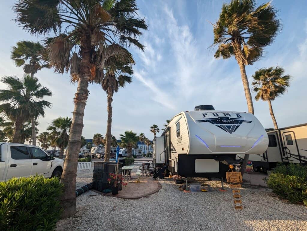 A fifth-wheel in a tropical campsite in Texas.