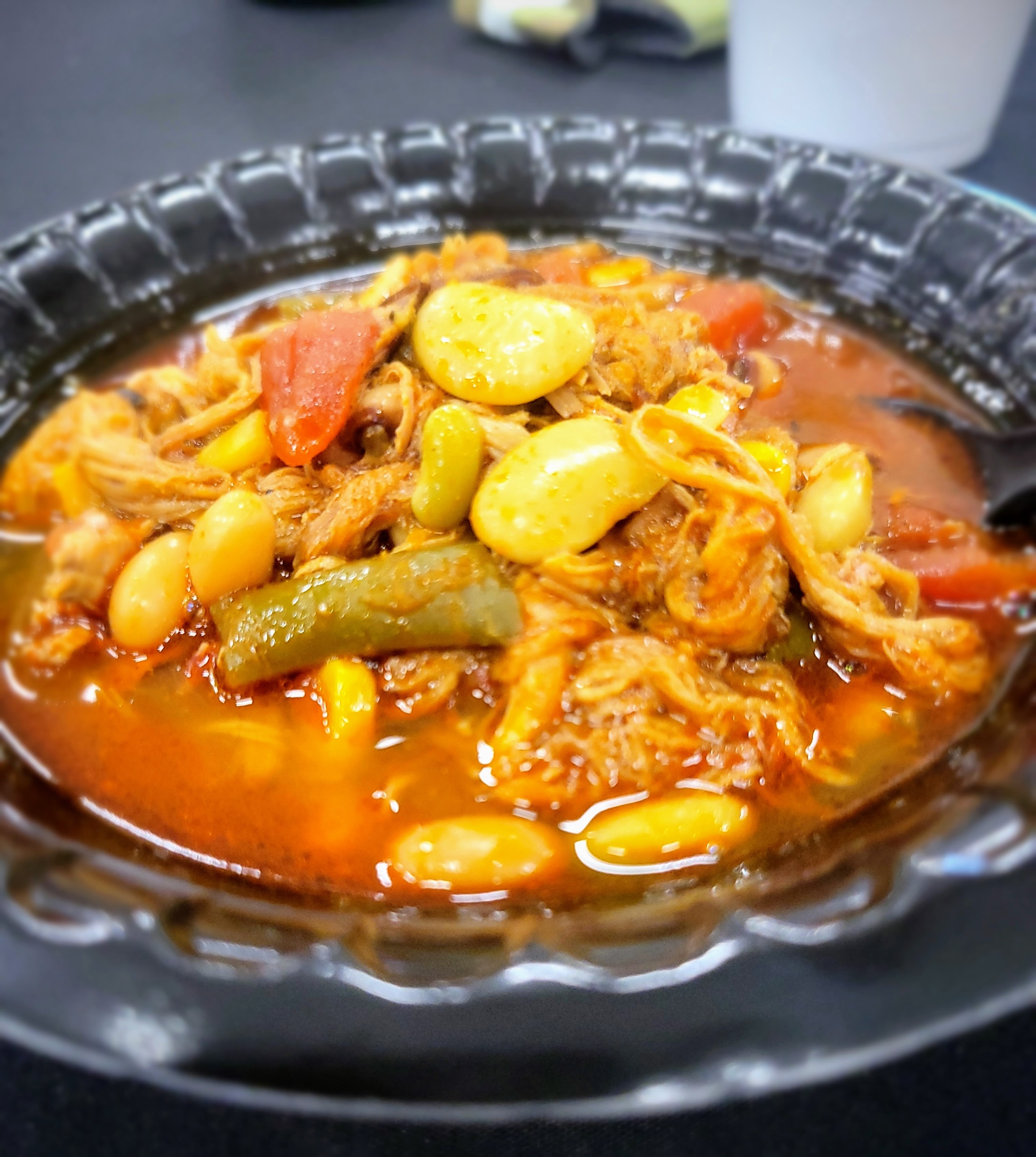 A bowl of Brunswick stew containing squirrel meat and vegetables in a tomato broth.