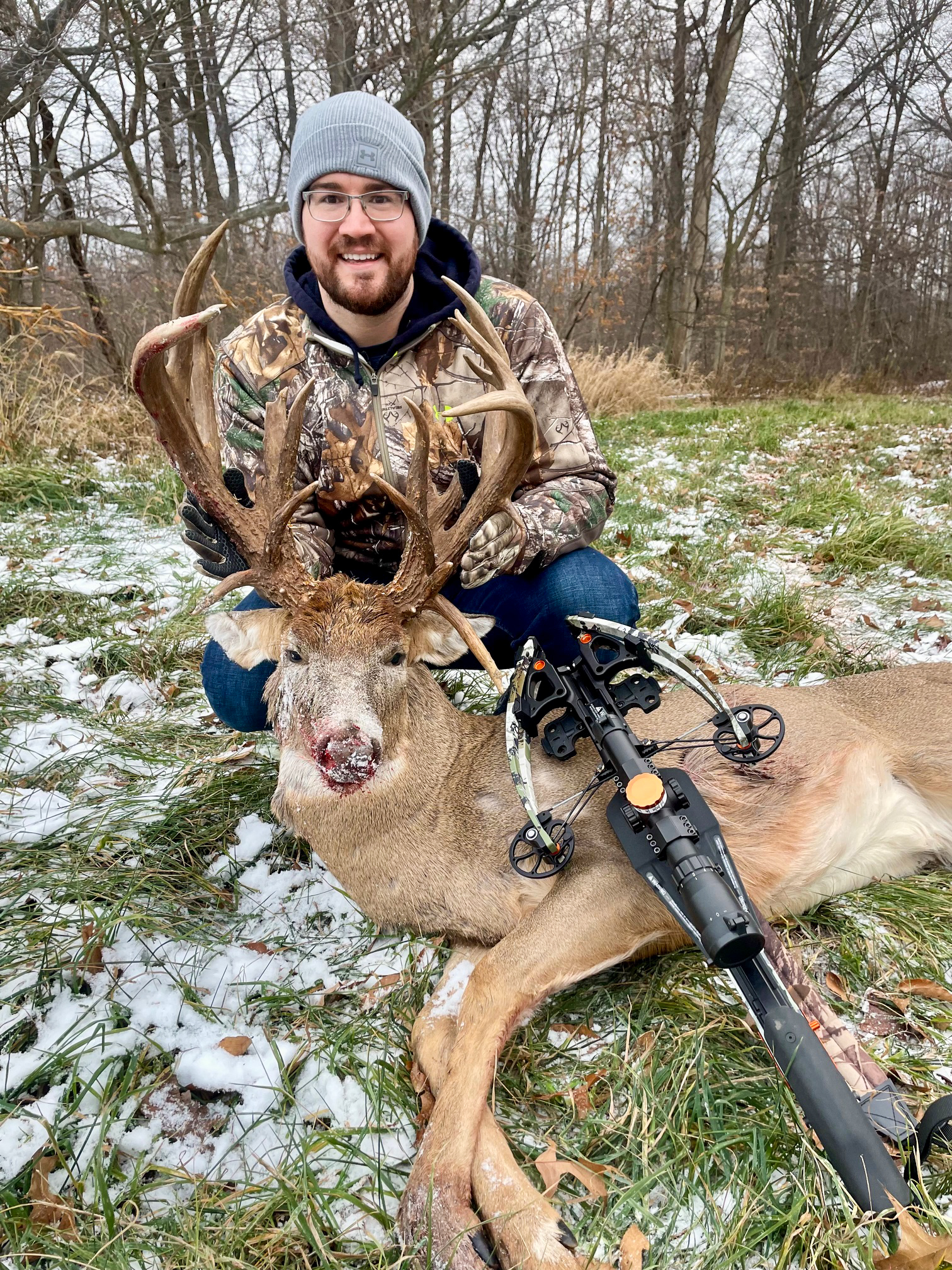 A hunter with a big buck.