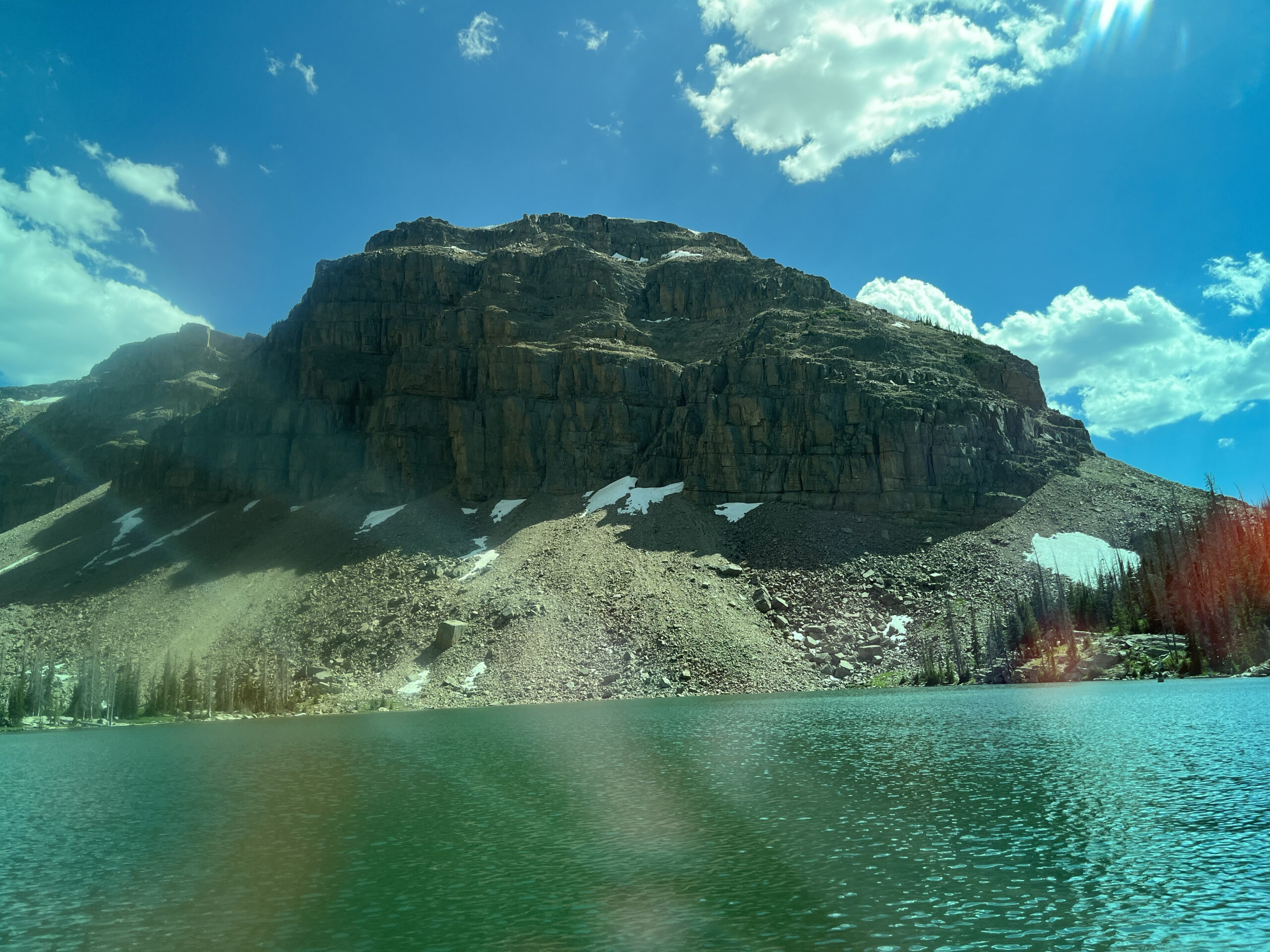 A mountain sits across a lake.