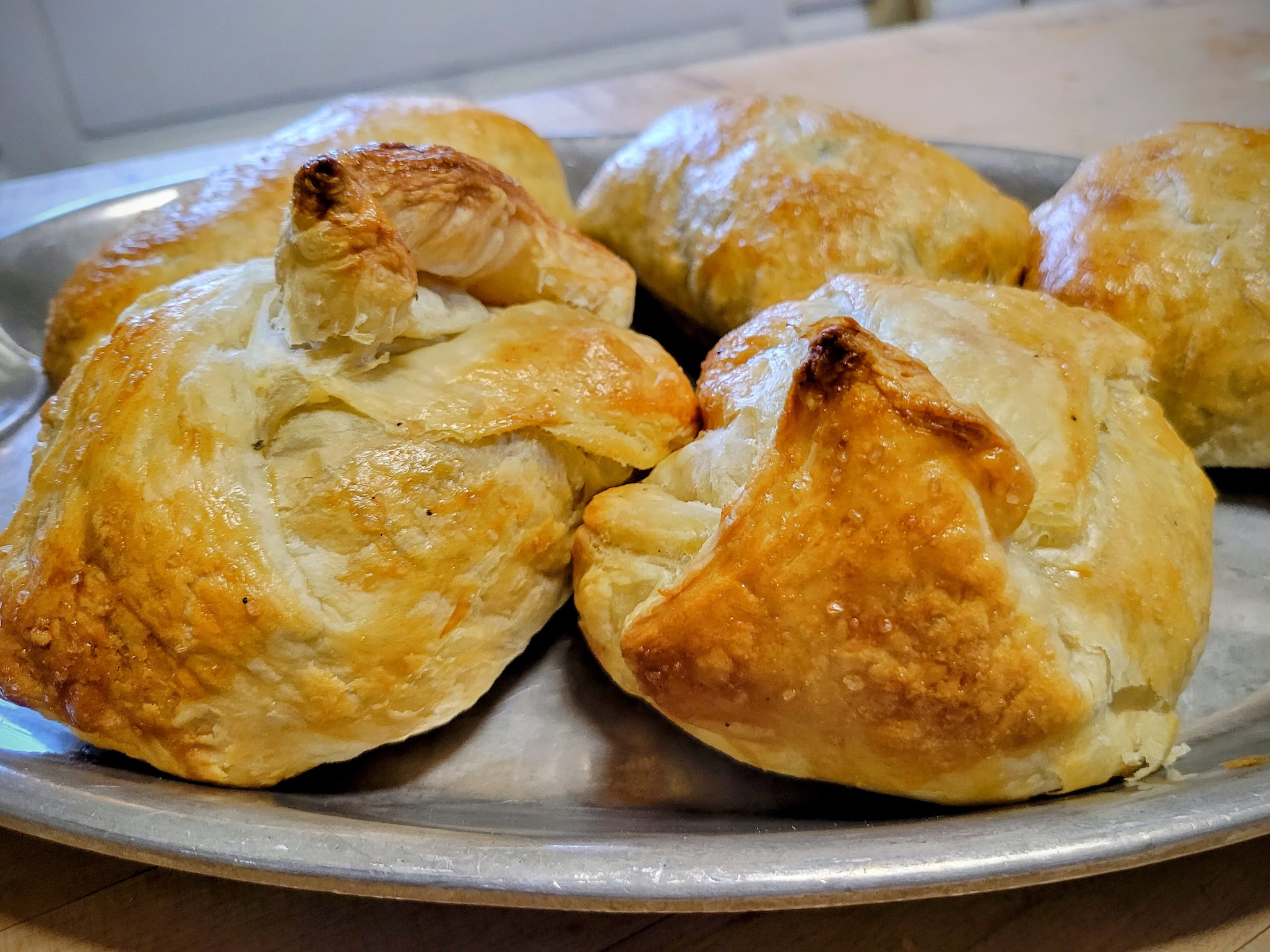 Puff pastry venison Wellingtons sit on a silver tray.