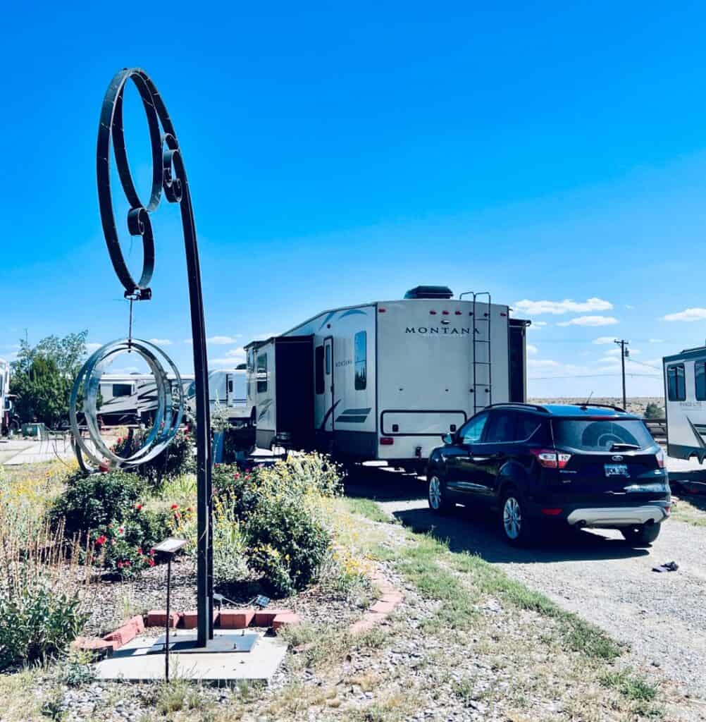 A trailer and SUV in a campsite at Santa Fe Skies RV Park.