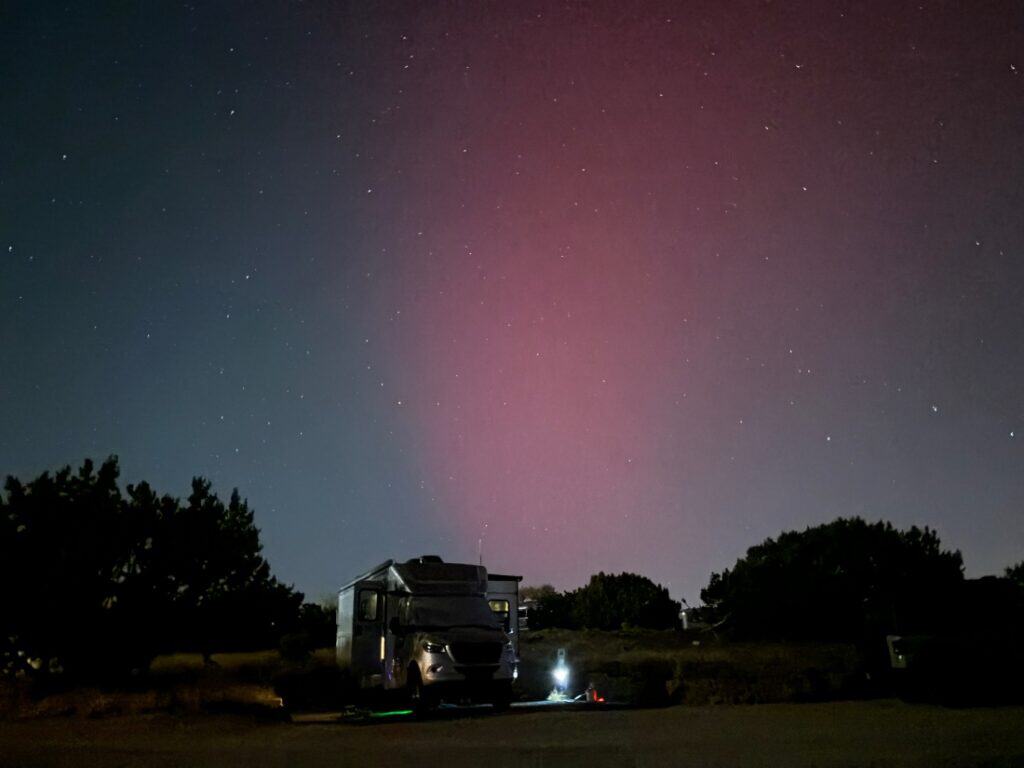 A nighttime view of an RV and the skies at Santa Fe Skies RV Park.