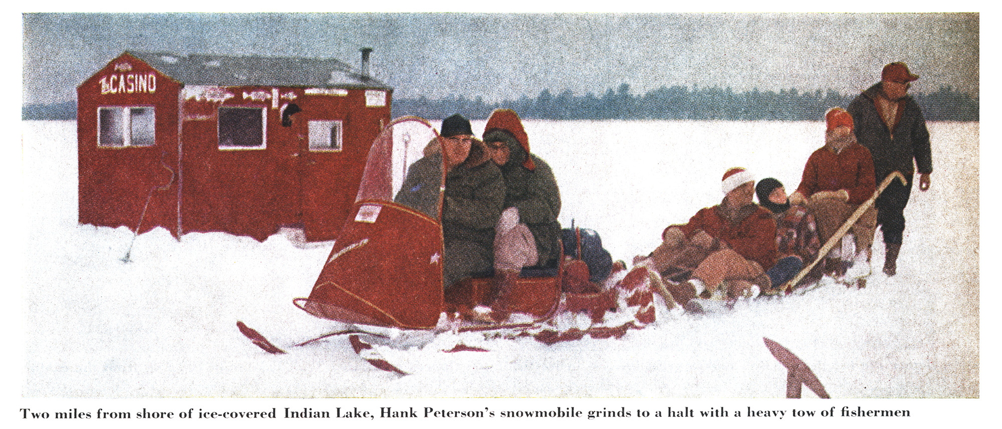 A photo of an old red snowmobile.