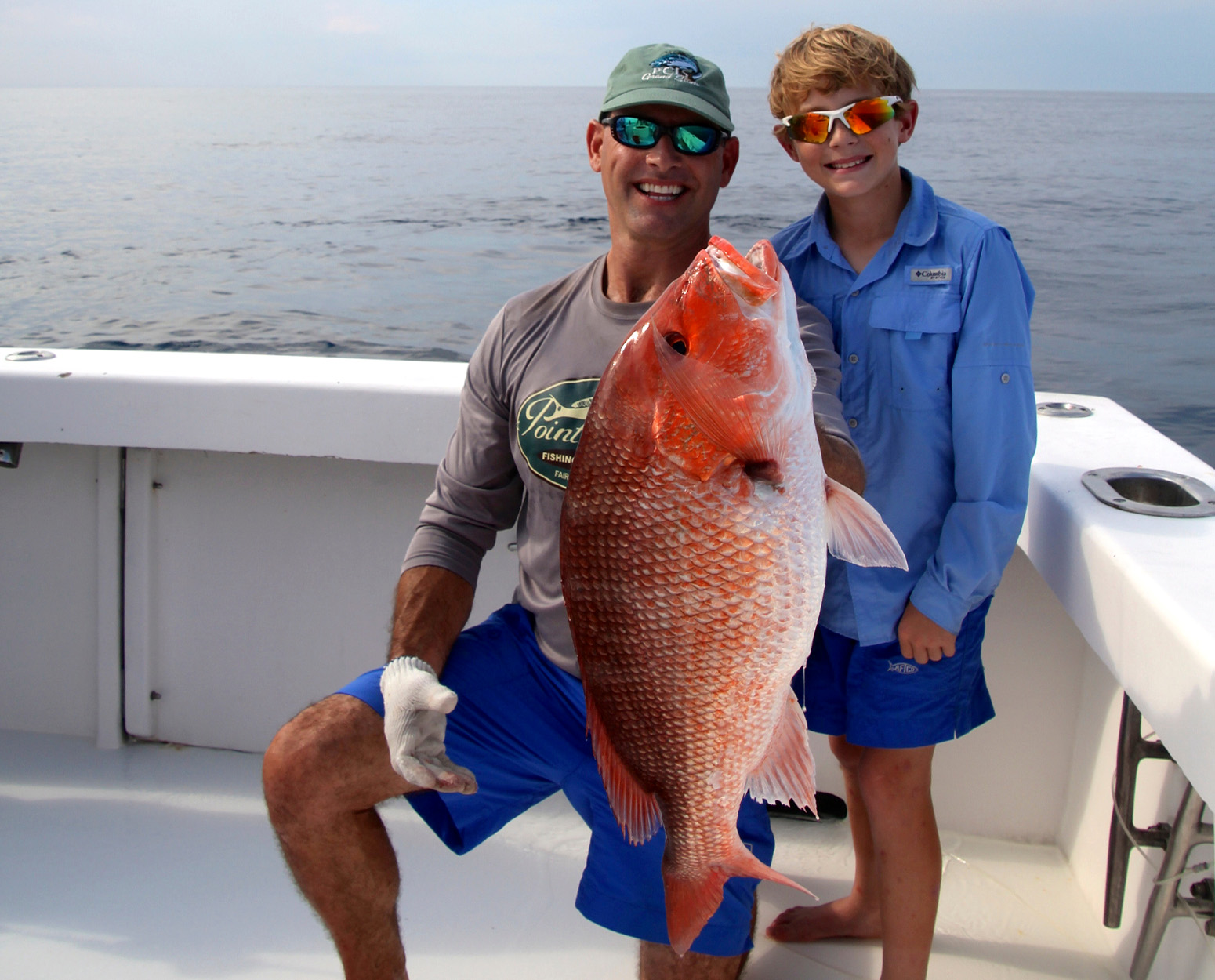 Two anglers with a snapper caught in the South Atlantic.