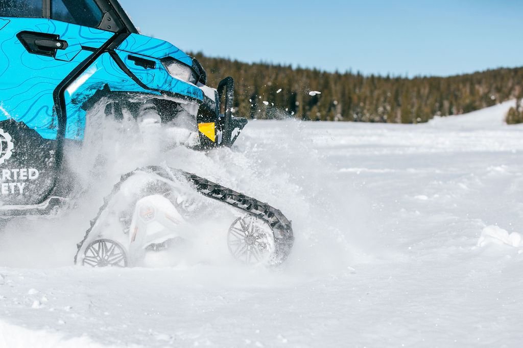 The Can-Am Apache XC LT tracks in action in the snow.