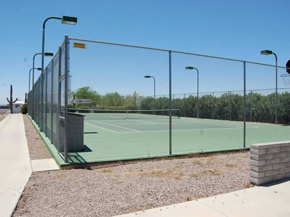 Tennis court under blue sky.