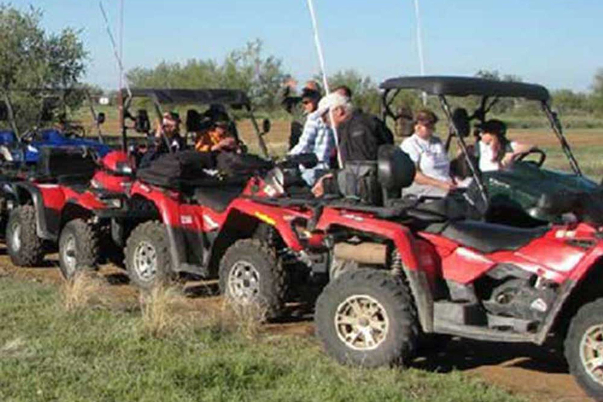 ATV rider prepare for adventure with red quad vehicles.